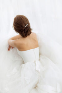 Brides beauty. Young woman in wedding dress indoors
